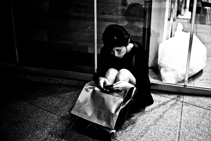 Woman sitting after a long day shopping at Shibuya