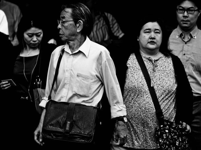 Some salarymen and women at Shimbashi station going to work. Street Photography by Victor Borst