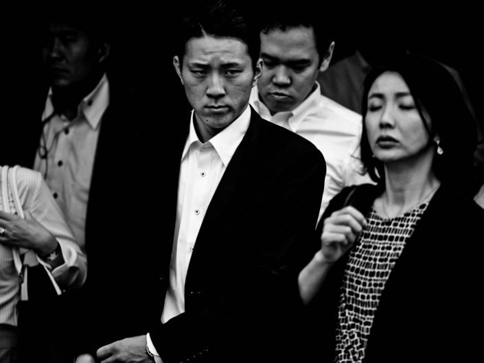 A few salarymen and women at Shimbashi station going to work. Street Photography by Victor Borst