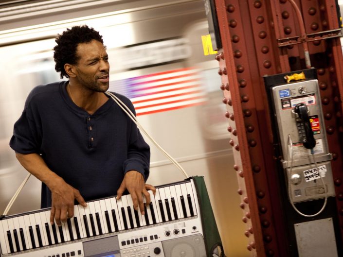 New York Subway Keytar photo with a passing metro in the background. Street Photography by Victor Borst