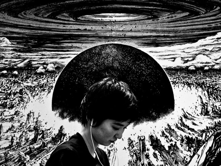 Japanese girl in front of explosion from the anime Akira. Street Photography by Victor Borst